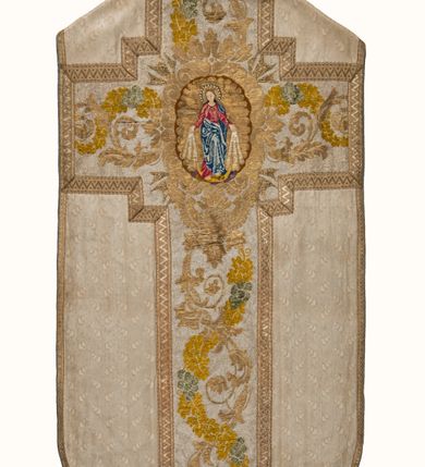 Zdjęcie nr 2: Boki ornatu z białej tkaniny wiskozowej, żakardowej. Wzór o kompozycji rzędowej z motywem trzech nachodzących na siebie okręgów, zwróconych w prawo lub w lewo i przesuniętymi o połowę szerokości raportu w kolejnych rzędach.
Tylna preteksta z tkaniny półjedwabnej o splocie atłasowym, lansowanej nićmi o oplocie metalowym gładkim i karbowanym oraz nićmi bawełnianymi o splocie rządkowym, całość zabezpieczona ściegiem łańcuszkowym. Kompozycja złożona z dwóch przeplatających się wici; złota ze stylizowanymi strzępiastymi liśćmi i wolutowo wygiętymi witkami, żółto-zielona z liśćmi i owocami winnego krzewu. Na przecięciu ramion krzyża preteksty medalion z wizerunkiem Matki Boskiej Apokaliptycznej. Przednia preteksta haftowana na kanwie ściegiem liczonym nićmi bawełnianymi i wełną; na białym tle główki kwiatów w otoczeniu strzępiastych liści, ułożone wertykalnie, w zimnych odcieniach zieleni, brązu i szarości. 
Galony tkane z nićmi o oplocie miedzianym w wątku, w dwóch szerokościach, z motywem zygzaka, jeden lub dwa brzegi ząbkowane.
Podszewka z tkaniny wiskozowej, żakardowej, w kolorze niebieskim. Wzór o kompozycji pasowej z motywem geometrycznym oraz dwóch rodzajów gałązek z kwiatami  i listkami, zwróconymi w prawo lub w lewo i przesuniętymi o połowę szerokości raportu w kolejnych pasach.
